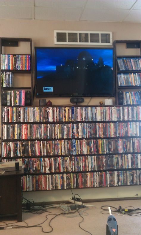 Blu Ray/ DVD Shelves built around my flat screen in my living room. I used only 1"x4" (fur) and decking screws and a can of wood stain. Total cost was less than $30! Ikea Dvd Storage, Dvd Storage Tower, Dvd Storage Ideas, Dvd Storage Cabinet, Movie Shelf, Movie Storage, Diy Dvd Storage, Diy Dvd, Dvd Storage Shelves