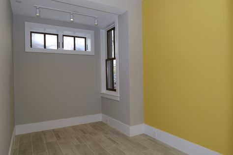 Small basement bedroom with Firefly Yellow accent wall (Benjamin Moore) and egress window Yellow And Gray Painted Walls, Accent Wall Benjamin Moore, Yellow Accent Wall, Wall Paint Colour Combination, Warm Bedroom Colors, Small Basement Bedroom, Yellow Painted Walls, Tradition Ideas, Yellow Accent Walls