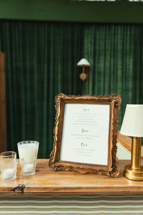 framed bar signage and table lamp on a custom linen and wood bar at a tented wedding reception in charleston south carolina Wedding Table Stationary, Wedding Reception Green, Bar Signage Wedding, Antique Wedding Decor, Mexico Museum, Wedding Bar Signage, Tented Wedding Reception, Gift Table Wedding, Bar Signage