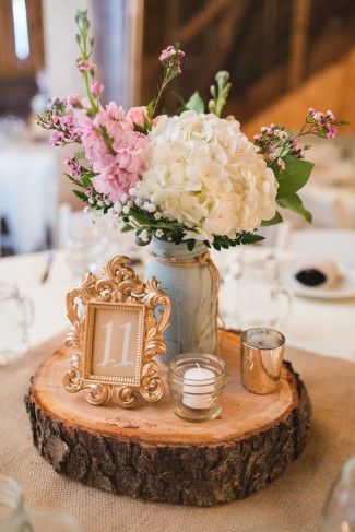 Wedding reception center piece on a wood slab with gold frame for table number and white hydrangeas Vintage Wedding Centerpieces, Wedding Centerpieces Mason Jars, Rustic Wedding Decorations, Mason Jar Wedding, Rustic Wedding Centerpieces, Vintage Wedding Decorations, Rustic Barn Wedding, Shabby Chic Wedding, Wedding Table Decorations