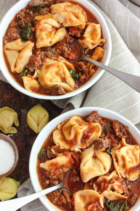 This soup comes with a memory: a bowl of hearty soup served by my mother-in-law one chilly fall afternoon many years ago. I remember the tomatoey broth being so complex yet so comforting, and the cheesy tortellini were a brilliant touch. I asked her for the recipe, but she, being the MacGyver of the kitchen that she is, didn’t have anything to give — it was a one-time-only melting pot of a week’s worth of leftovers Sausage And Tortellini Soup, Sausage And Tortellini, Sausage Tortellini Soup, Hearty Soup Recipes, Pastas Recipes, Hearty Soup, Spinach Soup, Tortellini Soup, Soup Dinner