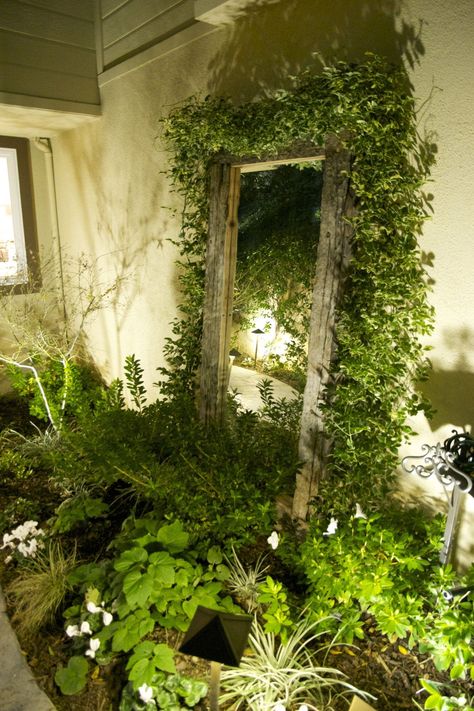 Add depth and visual interest to your outdoor space by strategically placing a mirror in the garden, whether against a wall, fence or shed, creating the illusion of more space and reflecting the beauty of your garden. Check our page for more garden lighting ideas! Outdoor Mirrors Garden Wall, Mirror In The Garden Ideas, Garden Mirrors On Fences, Mirror In Garden Ideas, Mirror In Garden, Mirrors In Gardens, Garden Mirrors Ideas Outdoors, Diy Garden Mirror, Indoor Secret Garden