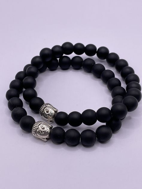 These beautiful Black Onyx Bracelets with silver plated Buddha head are handmade in Nepal. Strong elastic cord to fit most wrist sizes. Beautiful Natural Gemstone Bracelet with Buddha's head for Meditation or just for its beauty as fashion. Each bracelet has beautifully polished 8mm Gemstone beads and a very well-detailed silver-coloured Buddha head bead. It would make a lovely gift for your loved ones. Visit our Etsy shop for more: https://www.etsy.com/uk/shop/KathmanduCollections Male Bracelets, Buddha Bracelets, Wrist Mala, Mala Meditation, Buddha Beads, Bracelet Wrist, Black Onyx Bracelet, Beads Bracelet Design, Buddha Head