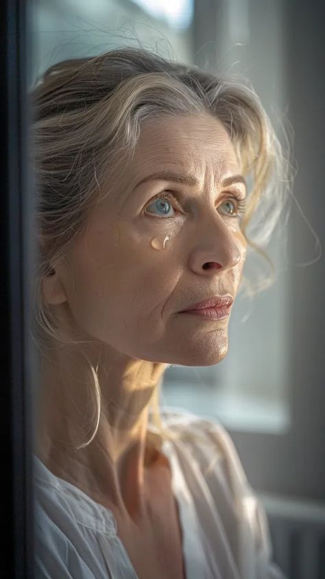 The photo shows a middle-aged woman looking out the window. Her expression is pensive and sad ->> more details in ai-img-gen.com Age Photography, Middle Aged Woman, Makeup School, Under My Skin, Middle Aged Women, Looking Out The Window, School Makeup, Blonde Hair Blue Eyes, Story Board