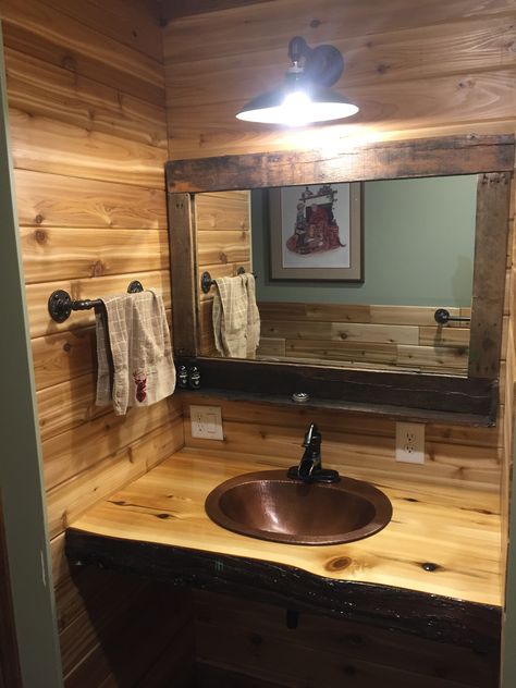 Finished my #rustic bathroom vanity top with this copper sink and cedar epoxy poured countertop. Did a #pallet wood mirror and an old #farm light over them. Cedar Bathroom, Farm Accessories, Bathroom Lighting Over Mirror, Rustic Bathroom Lighting, Farm Light, Rustic Sink, Cabin Bathroom, Rustic Bathroom Vanities, Rustic Restaurant