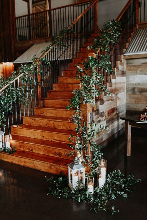 Staircase at Stone Crest venue with smilax greenery and candles.  KGC Photography Greenery On Staircase Wedding, Winter Wedding Staircase Decor, Greenery On Stairs Wedding, Wedding Staircase Greenery, Fall Wedding Staircase Decoration, Wedding Ceremony On Stairs, Bridal Staircase Decor, Stair Case Wedding Decoration, Wedding Banister Decor Railings