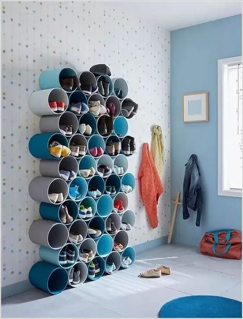 Make Shoe Storage from PVC Pipes123 Creative shoe storage solution using cylindrical shelves in a modern and colorful room with coats and bags hanging nearby. | Sky Rye Design Organization Ideas For Toys, Pvc Pipe Storage, Toddler Room Organization, Toy Storage Ideas, Extra Space Storage, Toy Storage Solutions, Storage Room Organization, Storage Kids Room, Project Organization