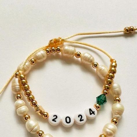 🐾 marley & yelby on Instagram: "Graduation 👩‍🎓  Bracelets are sold separately or as a set  Two bracelets shown 2024 bracelet is customized with a birthstone and the size is adjustable.  Freshwater pearl accented with 14k gold plated beads and a chunky heart charm  Etsy link in bio  #GraduationDay • #CongratulationsGraduate • #ProudMoment • #GradLife • #ClassOf2024 • #Graduation2024 • #NewChapter • #SuccessStory • #DreamBig • #AchievementUnlocked • #GraduateLife  #bracelts #armcandy #etsy #shopsmall" Class Of 2024 Bracelets, Flower Graduation, Graduation Bracelet, Graduation 2024, Diy Bracelet Designs, Proud Mom, Diy Bracelet, Christmas Collection, Arm Candy