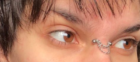 bridge piercing chain #bridgepiercing #browneyes #eyes #fashion #fashioninspo #altfashion #androgynous #piercing Nose Bridge Piercing Chain, Bridge Piercing Chain, Cute Bridge Piercing, Bridge Piercing Jewelry, Goth Scrapbook, Piercing Bridge, Nose Bridge Piercing, Nose Peircing, September Aesthetic