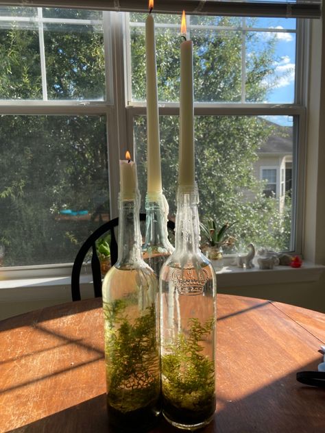 Terrarium With Candles, Witchy Spring Decor, Wine Candle Holders, Witchy Terrarium, Witchy Candle Holder, Glass Candle Holders Decorating Ideas, Wine Bottle Terrarium, Witchy Decor Witch Cottage, Wine Bottle Candle Holders