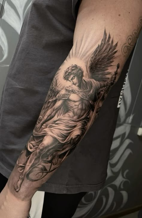 Icarus Forearm Tattoo, St Gabriel Tattoo, Men’s Family Arm Sleeve Tattoo, Angelic Tattoos Men, Arcangel Michael Tattoo, Angel Wing Forearm Tattoo, Mens Angel Tattoo, Guardian Angel Tattoo Sleeve, Scroll Tattoo For Men