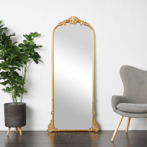 Place this ornate wall or floor mirror in a sunlit parlor or at the end of an elegant corridor, its radiant reflections and intricate detailing will create an enchanting focal point. This item ships in 1 carton. Floor Mirror Decor, Gold Floor Mirror, Barbie Things, Tall Mirror, Golden Mirror, Floor Standing Mirror, Gold Framed Mirror, Golden Wall, Kelly Clarkson Home