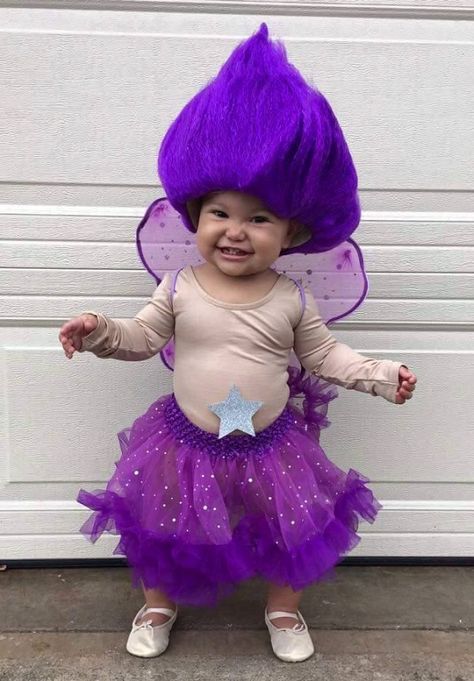 I came across this adorable Halloween costume idea from Rachelle Joseph and she was so sweet to let me share with you guys! All you need is a glittery skirt, a long sleeve skin colored leotard, ballerina slippers, purple fairy wings, and a troll wig! Darling! You could make your child into whatever colored troll you … Troll Doll Halloween Costume, Troll Doll Costume, Cupcake Halloween Costumes, Troll Halloween Costume, Doll Fancy Dress, Troll Costume, Crafty Morning, Fairy Halloween Costumes, Frozen Costume