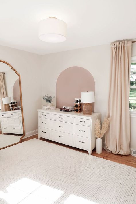 Neutral office with tan wall arch behind a white dresser with a white rope rug and gold mirror. Boho gold, neutral accents. Pink Painted Arch Accent Wall, Paint Arch Nursery, Painted Arch Behind Dresser, Nursery Accent Wall Behind Dresser, Painted Arch In Nursery, Arch In Nursery, Mauve Dresser Nursery, Painted Arch Wall Nursery, Mauve Nursery Wall