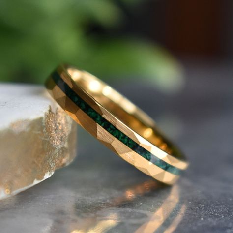 Discover the perfect blend of sophistication and strength with our 4mm Gold Hammered Tungsten Ring featuring a captivating Malachite Inlay. The hammered gold detailing adds a distinctive touch, while the malachite inlay not only introduces a burst of color but also brings with it the potential benefits of promoting balance and transformation. Embrace a durable symbol of your commitment, enriched with the unique properties of malachite – a stone believed to encourage positive energy and personal Men's Wedding Ring Gold, Mens Wedding Rings Gold Unique, Men's Engagement Rings For Him, Gold Rings For Men Unique, Men’s Ring, Men’s Rings, Men’s Wedding Rings, Men Gold Rings, Men Rings Gold