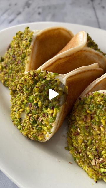 Ben Siman Tov on Instagram: "Pistachio & Cream Kataif 

You can find the full recipe on my website (link in bio 💃🏽)

Ramadan is around the corner and and it’s time to make one of my favorite snacks for this holiday. Kataif is an Arab dessert commonly served during the month of Ramadan. The name refers to a dessert as a whole and, more specifically, the batter. It is a sort of sweet loaded pancake (similar to a Scottish crumpet) filled with cream or nuts. The cream here is based on semolina with a kiss of orange blossom syrup. After preparing the pancakes, I fold them in half and fill with the cream. I then dip them in freshly ground pistachios for another layer of texture. I find that the pistachios complete the flavor profile for the whole treat. These kataif are relatively not as sweet Pistachio Pancakes, Pistachio Cream, Month Of Ramadan, Crumpets, Flavor Profiles, Favorite Snack, Freshly Ground, A Kiss, Website Link