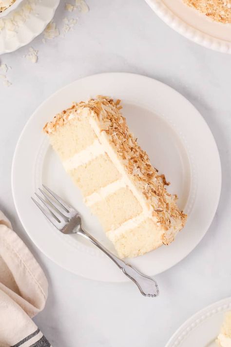 This coconut layer cake has LOTS of coconut flavor! A soft and tender cake infused with coconut cream, coconut extract, and coconut flakes is wrapped in silky coconut swiss meringue buttercream. Coconut Layer Cake, Coconut Cream Cake, Cream Of Coconut, Lemon Layer Cakes, Coconut Extract, Meringue Cake, Coconut Frosting, Layer Cake Recipes, Spring Cake