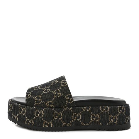 This is an authentic pair of GUCCI Jacquard Black Denim GG Monogram Angelina Platform 55mm Slide Sandals 38 in Black and Ivory. These slides are crafted of denim monogram canvas and feature single strap across the foot and a 2 inch platform. 1387327 Black Gucci Platform Slides, Gucci Platform Slides, Black Gucci Slides, Gucci Slide, Gucci Slides, Gucci Sandals, Gg Monogram, Platform Slides, Wide Straps