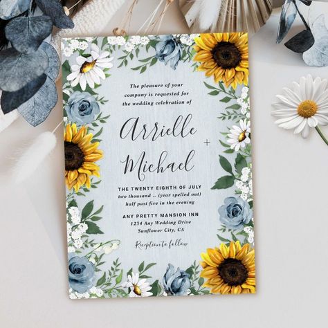 Design features a dusty blue/gray wood grain background with a wreath made of sunflowers, daisies, roses in dusty blue shades, baby's breath over various types of botanical watercolor greenery elements. Blue Sunflower Wedding, Leaves Bouquet, Modern Greenery, Sunflower Themed Wedding, Breath Flowers, Sunflowers And Daisies, Rose Wedding Invitations, Roses Wedding, Eucalyptus Wreath