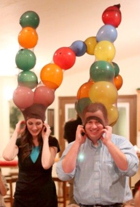 Have guests split into teams of three and give them 15-20 balloons and a pair of pantyhose with the openings at the feet. One person wears the pantyhose on their head; the fastest team to blow up all balloons and stuff them into the pantyhose wins.  Get the tutorial at Party Games Plus.  - WomansDay.com Funny Christmas Party Games, Christmas Games To Play, Funny Christmas Games, Balloon Games, Xmas Games, Fun Christmas Party Games, Christmas Games For Kids, Fun Christmas Games, Christmas Games For Family