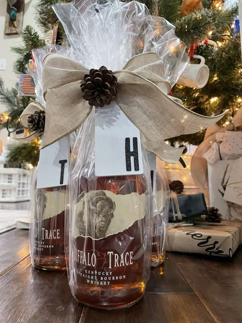 Whiskey: A gift that keeps on giving! Add some celephane and a bow for a quick Christmas Flair! Gift Wrap Liquor Bottle Ideas, Whiskey Christmas Gift, Wrapping Whiskey Bottle, How To Gift Wrap Bourbon Bottle, Wrap Liquor Bottle Gift, Celephane Wrapping, Wrapping Alcohol Bottles Gift, Whiskey Gift Basket, Bourbon Gifts Basket