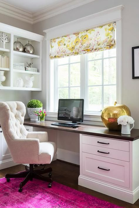 Chic home office features a built in desk adorned with bronze pulls accented with a beveled wood paired with a cream tufted rolling chair placed under windows dressed in a yellow floral roman shade alongside a hot pink overdyed rug. Cowboy Home Decor, Computer Desks, Office Library, Desk Inspiration, Creative Office, Handbag Storage, Office Area, Built In Desk, Office Desks