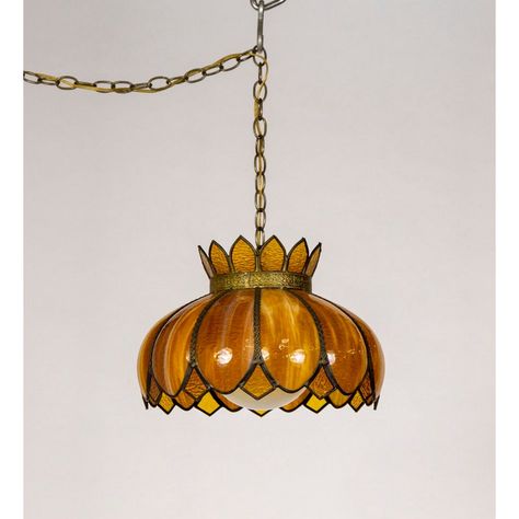 A mid-20th century, hanging light fixture in rich amber, gold, caramel, and yellow streaked slag and stained glass.  It is a lotus shape with scalloped and diamond petals and an ornately pressed brass band at the top and trimming the petals. A milk glass globe shade evenly diffuses the light. The glass turns golden brown and burnt sienna when lit. This pendant light has a long chain to swag from the ceiling and plug into the wall.   Very good condition. The wiring has been checked by our technic Hanging Pendant Lights Bedroom, Dinning Room Light Fixture, Tiffany Light Fixtures, Glass Lotus Flower, Swag Pendant Light, Stained Glass Pendant Light, Art Nouveau Lighting, Flower Swag, Lotus Shape