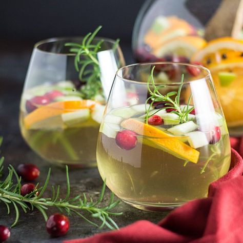 Pinot grigio with cranberries, orange slices, fruits and herbs is the absolute perfect holiday sangria! Holiday Sangria Recipes, Coffee Shots, Holiday Sangria, Christmas Sangria, Rum Cocktail Recipes, Apple Rose, White Sangria, Sangria Recipe, Christmas Drink