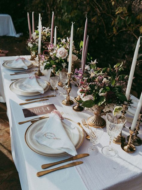 Wedding tablescape with lavender and white tapered candles in gold candle holders, mixed lavender, neutral and white bouquets, embroidered white napkins and gold cutlery Dusk Wedding Theme, Lavender And Gold Wedding, Romantic Neutral Wedding, Classy Reception, Engagement Table, White Wedding Table Setting, Purple White Wedding, Canyon Rose, White Bouquets