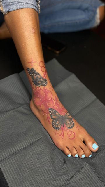 Butterfly Anklet Tattoo, Elephant Ankle Tattoos For Women, Baddie Foot Tattoos, Foot Tattoos For Women Butterfly, Foot Tattoos Black Women, Foot Tattoos For Women Black Woman, Foot Tattoos For Black Women, Pink Ink Tattoo On Dark Skin, Red Foot Tattoos