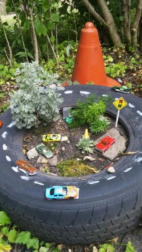 Tire Fairy Garden Ideas, Tire Yard Ideas, Tractor Tire Sand Boxes, Boys Fairy Garden, Tractor Tyre Ideas Kids Outdoor Play, Fairy Garden For Boys, Tractor Tyre Ideas, Tire Fairy Garden, Boy Fairy Garden Ideas