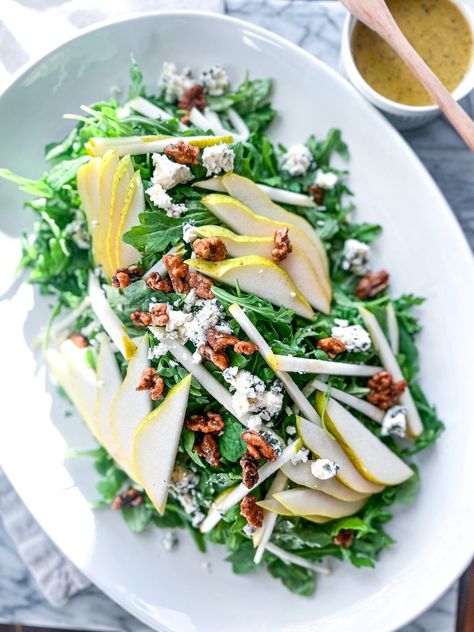 This Pear and Gorgonzola Salad with Arugula is the perfect salad for fall. Juicy pears, creamy Gorgonzola, peppery fresh arugula tossed with Quick and Easy Candied Walnuts, and our fabulous Honey Thyme Vinaigrette. Whether you are hosting a holiday dinner, a festive fall gathering, or simply looking for a fresh, seasonal salad, this salad will surely be a winning choice. Thanksgiving Salad Arugula, Arugula Pear Gorgonzola Salad, Salad With Pears And Gorgonzola, Pear Walnut Gorgonzola Salad, Fall Arugula Salad Recipes, Pear And Gorgonzola Salad, Arugula Salads, Salad For Fall, Thyme Vinaigrette