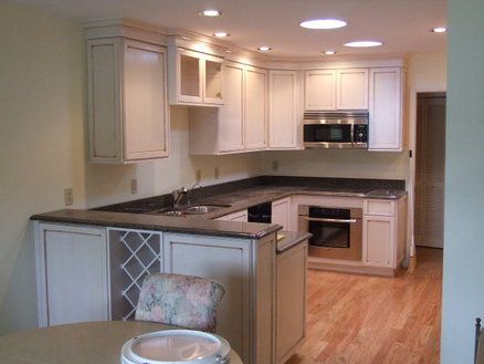 Galley-like kitchen with cream cabinets and dark granite Kitchen With Cream Cabinets, Kitchen Window Seat, Cream Cabinets, Dark Granite, Kitchen Window, Custom Kitchen, Window Seat, Cribs, Kitchen Cabinets