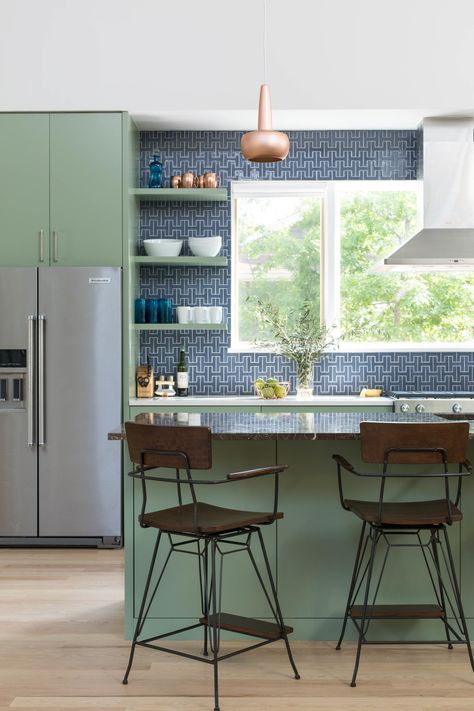 The Architect selected a recycled Fireclay Tile in Slate Blue and paired that with High Park paint from Benjamin Moore. Copper pendants from VITA accent the space. The vent hood is mounted in front of a large window, bringing in natural light and allowing for a view of the herb garden. Organic Modern Kitchen, Green Kitchen Designs, Blue Backsplash, Grey Countertops, Eclectic Kitchen, Fireclay Tile, Design Your Own Home, Open Kitchen Shelves, Dark Kitchen