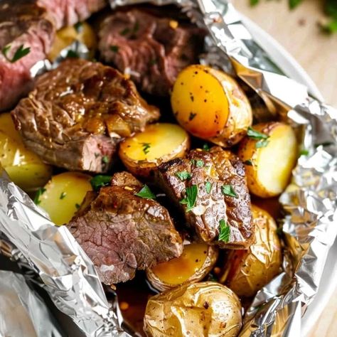 Fire up the grill and make these steak and potato foil packets! They're quick, easy, and cleanup is a breeze! Foil Wrapped Steak And Potatoes, Steal And Potato Foil Packs, Steak And Yellow Potatoes, Cajun Foil Packets Oven, Potatoe And Steak Foil Packets Oven, Grilled Steak And Potatoes, Steak And Potato Foil Pack Oven, Garlic Steak And Potato Foil Packs, Beef Foil Packets