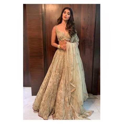 RAHTribe | Pooja Hegde ( @hegdepooja ) in a pale gold tulle lehenga for Deepika Padukone and Ranveer Signh's wedding reception held in… Indian Reception Outfit, Gold Lehenga, Simple Lehenga, Indian Outfits Lehenga, Nikkah Dress, Wedding Lehenga Designs, Lehnga Dress, Pooja Hegde, Traditional Indian Dress