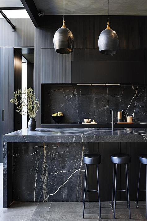 Contemporary black kitchen with bold marble countertops. Black Marble Bar Design, Minimalist Kitchen Black Countertop, Black Countertop Black Cabinets, Black Stone Kitchen Countertops, Black Modern Interior Design, Dark Luxury Kitchen, Black Marble Kitchen Countertops, Black Countertop Kitchens, Kitchen Black Marble