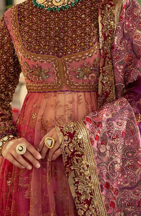 Pakistani Bridal Dress in Pishwas Frock Sharara Style is an iconic attire that has the perfect balance of traditional and glamorous look. Hand-crafted embellishments and luxury designs make this beautiful Pishwas Dress an epitome of beauty and your foremost priority. Pakistani Bridal Pishwas: Pakistani Bridal Pishwas Frock in an alluring pink shade is adorned with hand-crafted details of shimmering sequins, and motifs. Lavish floral designs and fine details of embroidery make this Pakistani Pish Pakistani Suits Bridal, Pink Bridal Pakistani, Ghera Embroidery Designs, Pishwas Designs, Heavy Anarkali Dress, Floral Indian Dress, Pakistani Wedding Guest Outfits, Frock Sharara, Angharka Style Frock