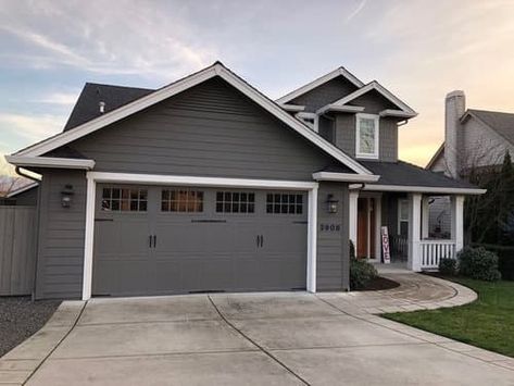 What Color Garage Door Goes with a Gray House? (14 Ideas) 18 Wood Garage Doors Dark Gray House, Garage Same Color As House, Grey House Garage Door Color, Peppercorn Sherwin Williams Garage Door, White House With Gray Garage Door, What Color Should I Paint My Garage Door, Garage Door Colors With Gray House, Dark Gray Garage Door, Dark Gray Exterior House Colors