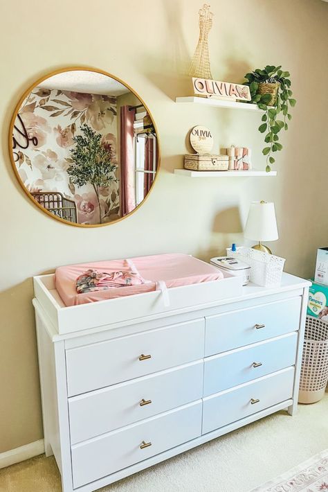 Decor inspo for a cute baby girl nursery: floral, blush and gold Shelves Above Nursery Dresser, Nursery Changing Table Wall Decor, Mobile Home Nursery Ideas, Above Nursery Dresser Decor, Above Changing Table Decor, Nursery Dresser Ideas, Baby Girl Nursery Theme, Nursery Ideas For Girls, Nursery Room Decor Ideas