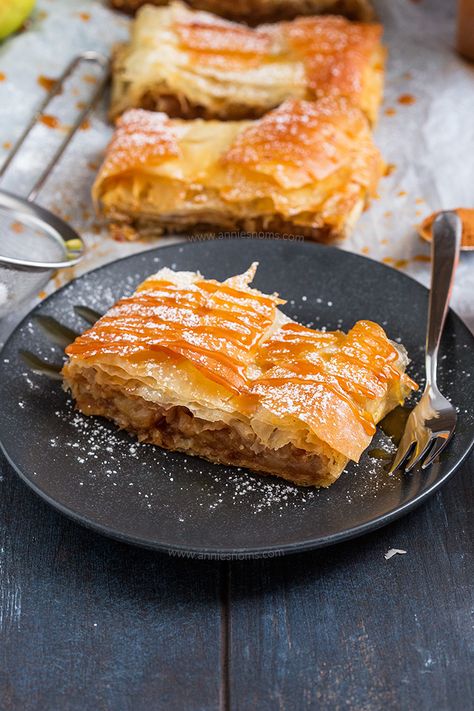 This quick and easy Apple Strudel is made with sheets of ready made filo pastry and filled with a spicy, sweet apple mixture. From prep to table in under an hour, this is perfect for feeding a crowd! Apple Strudel Phyllo Dough, Baked Apple Phyllo Tart, Apple Strudel With Phyllo Dough, Apple Filo Pastry Recipes, Phyllo Apple Recipes, Apple Strudel Recipe Phyllo Dough, Phyllo Dessert, Easy Apple Strudel Recipe, Easy Apple Strudel