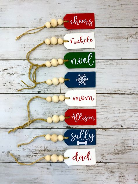 "Personalized Stocking Name Tags | Red, Blue, Green Wood Tags | Neutral Wood Beaded Gift Tags | Rustic Farm House Christmas Decor: Our wood beaded stocking tags are made to order with your personalization. Tags are approximately 8\" long from end of tag to end of jute. Each strand includes a total of 3 natural/neutral beads (20mm and 16mm). The tags (3 1/4\" X 1 5/8\") are hand painted or stained and sanded to provide a lightly distressed, rustic farmhouse look. Font and/or images are also hand Name Gift Tags, Diy Wood Tags, Wood Tags Ideas, Diy Christmas Name Tags, Stocking Tags Diy, Wood Gift Tags Diy, Hand Painted Gift Tags, Christmas Stocking Name Tags Diy, Farmhouse Tags Diy