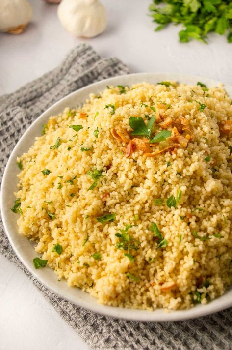 A delicious easy savory garlic couscous recipe with buckets of flavor, made in under fifteen minutes with just seven ingredients, it's the perfect quick side dish, and it's vegan and vegetarian friendly as well! It's made with tasty olive oil but you can also substitute butter. Delicious as is but you can also add in some Parmesan or a squeeze of lemon, or change up the herbs. Couscous Easy Recipe, Garlic Pearl Couscous Recipes, Flavorful Couscous Recipes, Delicious Couscous Recipes, Cous Cous Side Dish Recipes, Flavored Couscous Recipes, Couscous Seasoning Recipes, Garlic Butter Couscous, Couscous Side Dishes Dinner