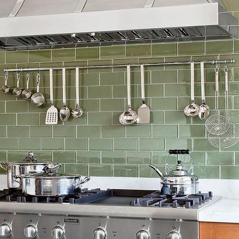 Thick, sage green glass tiles create a unique kitchen backsplash. The green tiles make white granite countertops demand attention as well. Colorful Subway Tile Backsplash, Green Subway Tile, Green Backsplash, White Granite Countertops, Unique Kitchen Backsplash, Subway Tile Kitchen, Casa Country, Kitchen Backsplash Designs, Glass Tile Backsplash