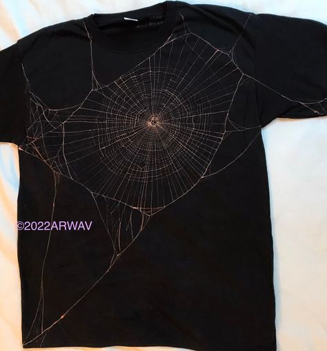 Spiderweb handpainted with bleach on to a black T-shirt. Available with just the spiderweb on the front, or connecting round to a second spiderweb on the back. If you're unsure what size to choose I recommend picking a larger one as fruit of the loom T-shirts are on the smaller side. Halloween Clothing Ideas, Bleach Spider Web Shirt, Spiderweb Bleach Shirt, Skull Clothing Design, Bleached Shirt Designs Alt, Spider Web Bleach Design, Black Shirt With Bleach Design, Bleach On Black Shirt, Bleach Dyed Clothes