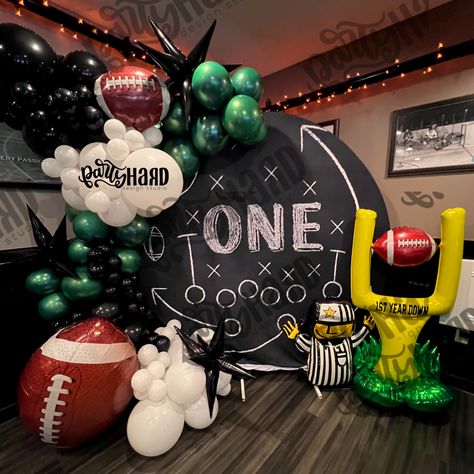 Football themed balloon for birthday boy turning one, 1st birthday party, green balloons, black balloons, white balloons, circle backdrops Football Theme Bday Decoration, Giants Themed Birthday Party, First Down Party Decor, Madden Themed Party, Football Birthday Party Balloons, Madden Football Birthday Party, First Year Down Football Birthday Balloons, First Year Down Football Birthday Backdrop, Football Themed Balloon Arch