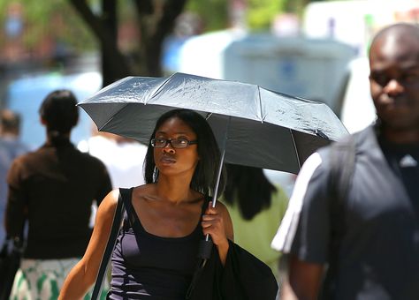 Josephine Adjei used an umbrella to protect herself from the sun. Sun Umbrella Fashion, Umbrella By Rihanna, Sharing An Umbrella, Maggie Holmes Parasol, Parosals Umbrellas Parasols, Summer Ray, Sun Protection, The Park, Umbrella