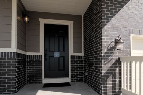 Black Brick House With White Siding, Grey And Black Brick House Exterior, Dark Grey Brick House, Dark Brick House Exterior Color Schemes, Dark Grey Brick House Exterior, Dark Brick House, Dark Brick House Exterior, Black Brick Exterior, Grey Painted Brick House