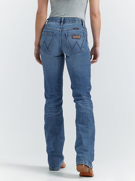 MADE FOR THE ULTIMATE RIDEAllow us to introduce you to Jade—part of the Women's Wrangler® Ultimate Riding Jean collection. This mid-rise relaxed bootcut jean for women is made of a comfortable cotton blend with stretch to keep up with riding, showing, and working. It's enhanced with a slightly pitched waistband that sits lower in the front and higher in the back for maximum comfort and coverage in the saddle as well as our signature no-gap waistband and flat comfort seams. The fit is a little looser for enhanced comfort. It comes with our signature five-pocket styling and "W" embroidery for marks of authenticity. Wrangler Jeans Aesthetic, Wrangler Outfits Woman, Wrangler Jeans Women's Outfit, Wrangler Jeans Outfit, Western Shopping, Wrangler Jeans Women's, Jean Collection, Wrangler Women, Riding Jeans