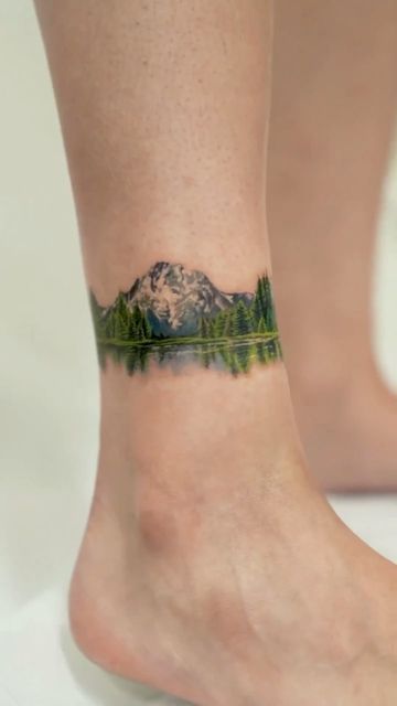 Landscape Back Tattoo Women, Natural Tattoos For Women, Forest Ankle Tattoo, Green Nature Tattoo, Forest Lake Tattoo, Detailed Mountain Tattoo, Mountain Color Tattoo, Nature Tattoos Color, Forest Tattoo Women